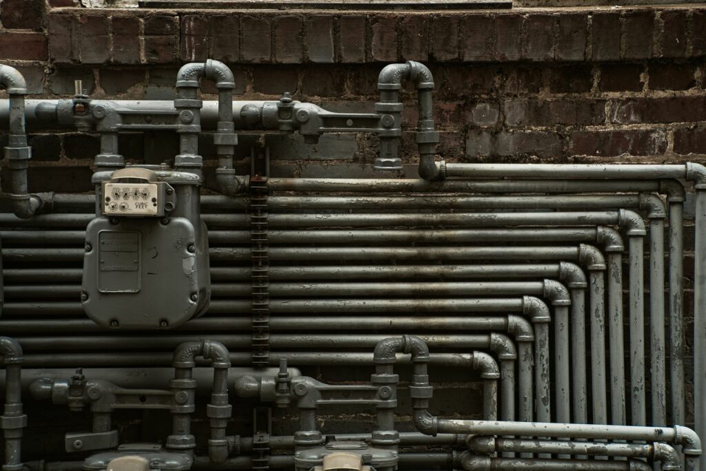 pipework and a meter on a brick wall