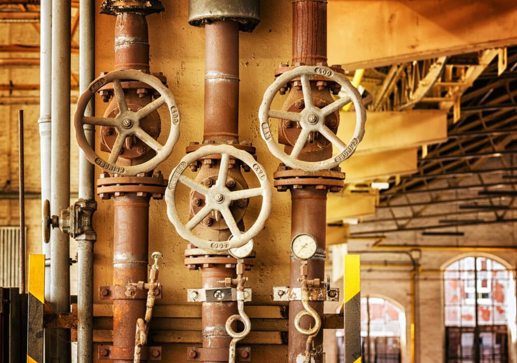 Industrial Pipe & Plumbing Malaysia: Managing "The Sweat" on Fluid Systems rusted pipes and valves in an ageing industrial plant